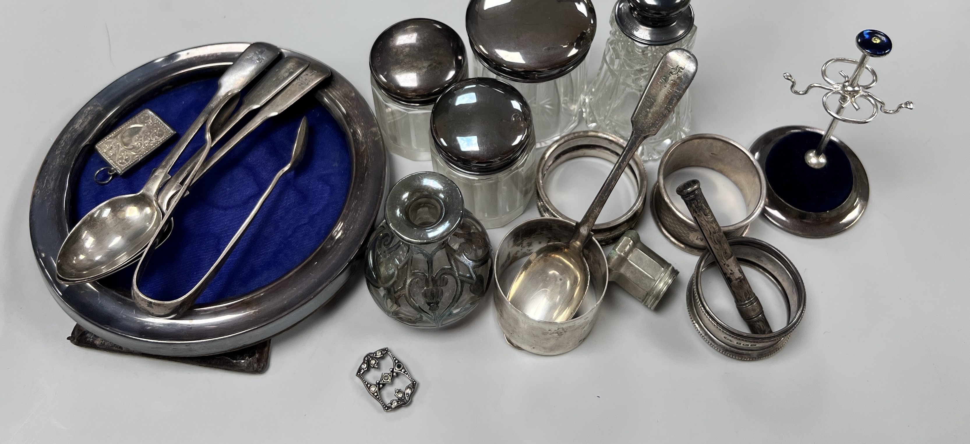 Sundry small silver including circular photograph frame, toilet jars, napkin ring ring tree etc.